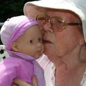 Mujer con demencia en una terapia con muñecas